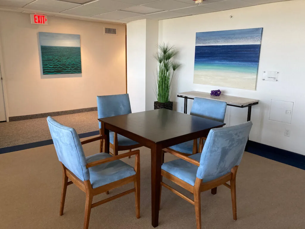 Two of three Lorimer paintings in a card room in Plymouth Harbor, Sarasota.